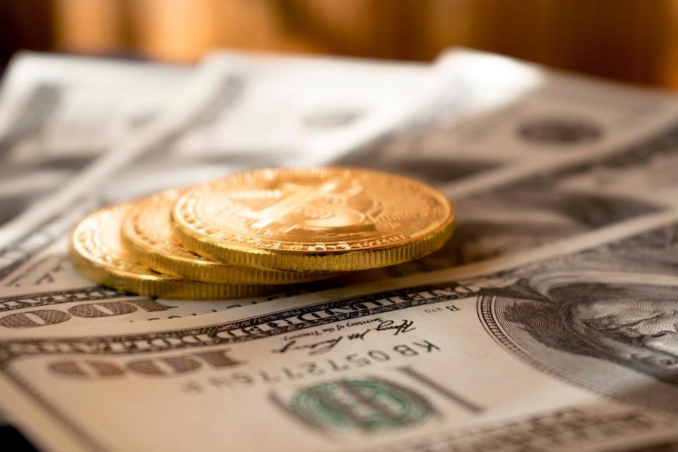 Hundred dollar bills and gold coins