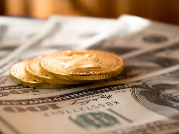 Hundred dollar bills and gold coins