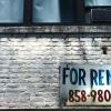 Brick wall and windwo with For Rent sign